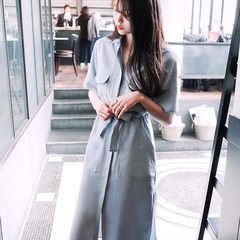 Spring/summer 2018 women`s blue tunic shows the trend of a long skirt with a thin lapel and a slit s The sky is blue l 